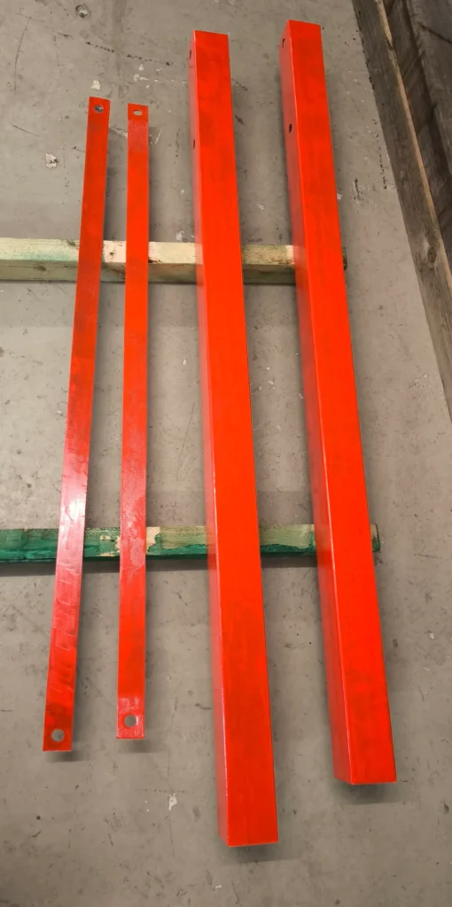 Fabricated steel parts painted red in Glasgow workshop